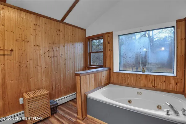 a bathroom with a bathtub and shower