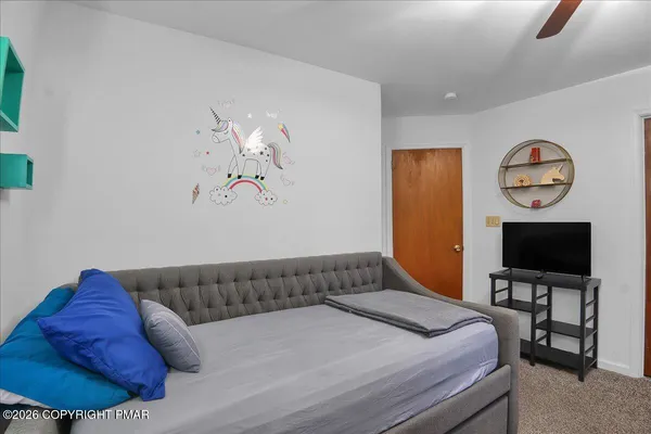 a bedroom with a bed and a flat screen tv