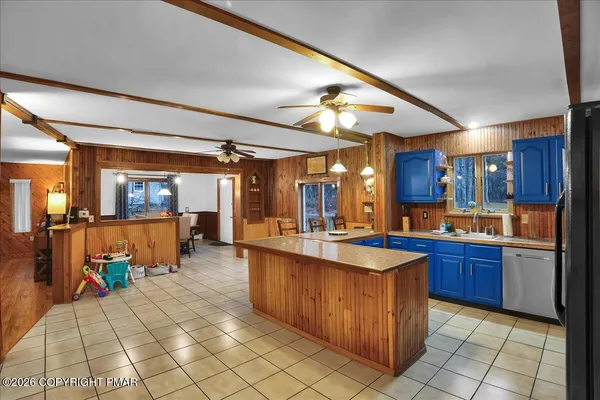 a large kitchen with cabinets and a table