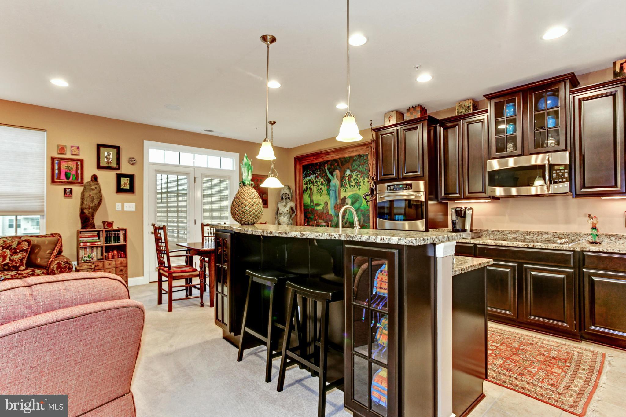 3632 Spring Hollow Lane Frederick, MD 21704 - Photo 20 of 30 a kitchen with stainless steel appliances granite countertop a stove top oven a sink dishwasher and cabinets with wooden floor