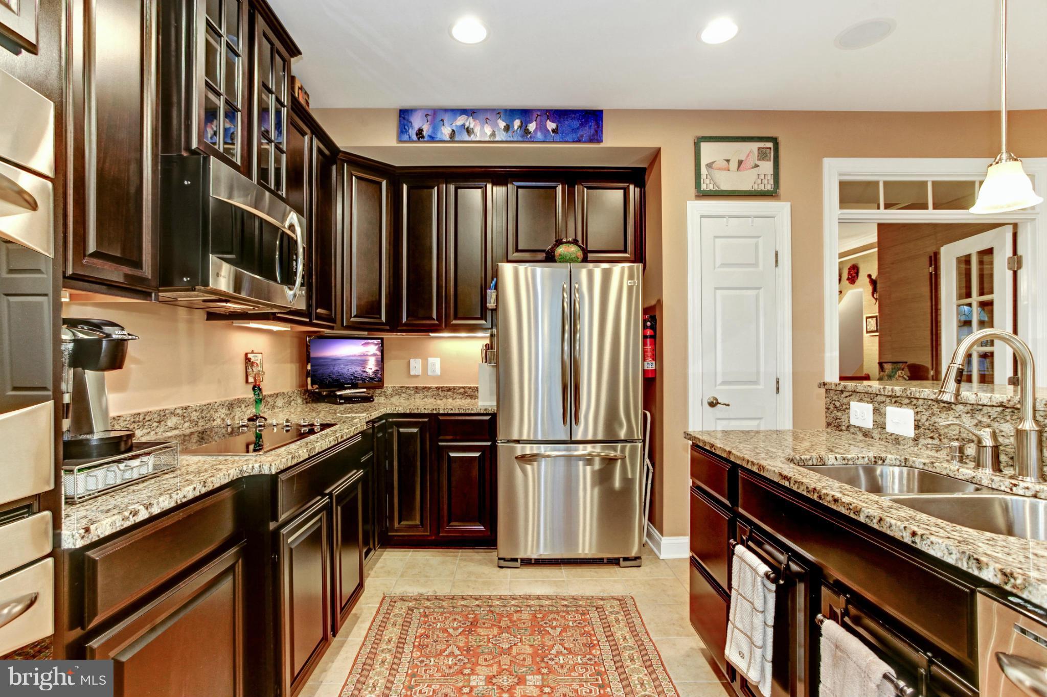 3632 Spring Hollow Lane Frederick, MD 21704 - Photo 22 of 30 a kitchen with granite countertop a refrigerator stove and sink