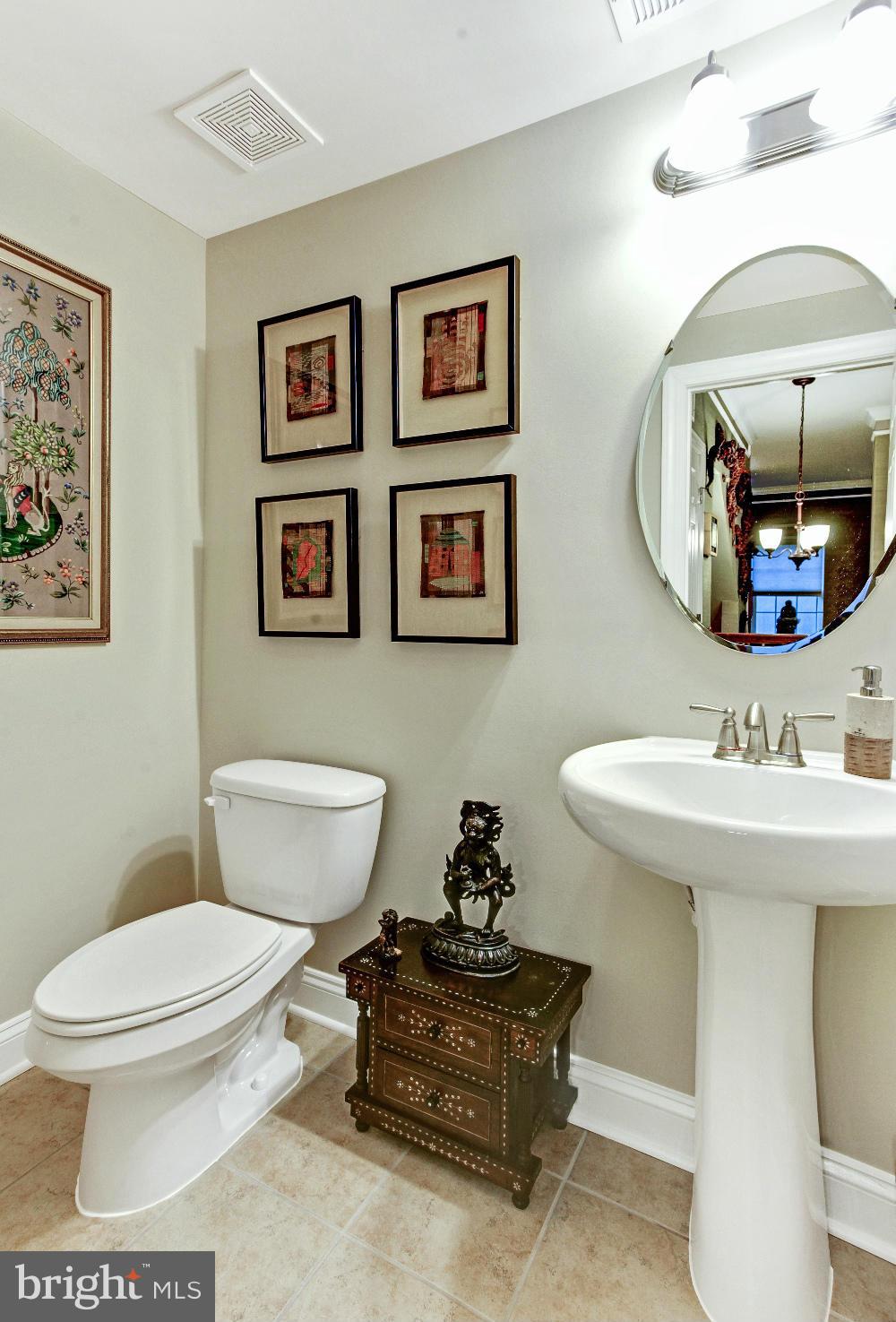 3632 Spring Hollow Lane Frederick, MD 21704 - Photo 29 of 30 a bathroom with a toilet a sink and a mirror