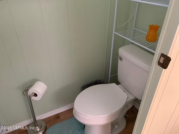a white toilet sitting next to a sink