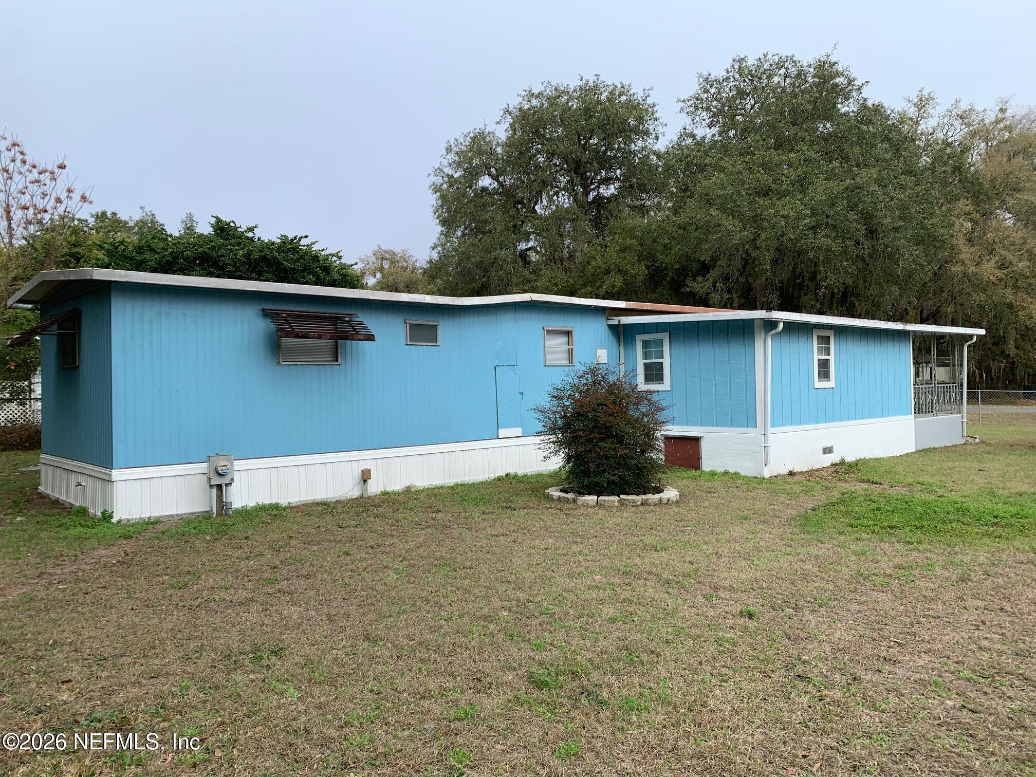 115 Sawyer Street Interlachen, FL 32148 - Photo 15 of 24 a house with trees in the background