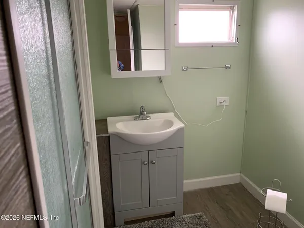 a bathroom with a sink a window and vanity