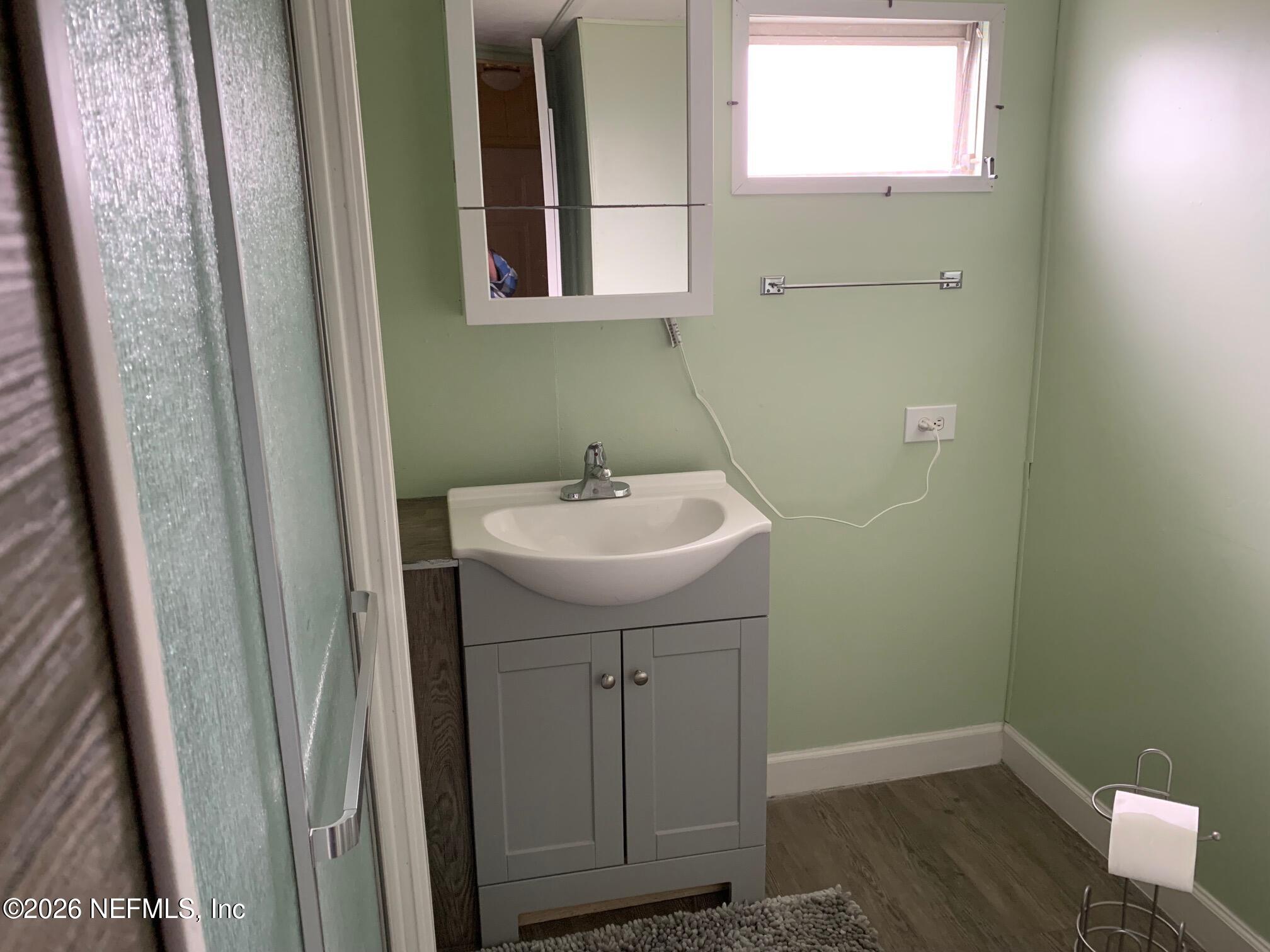 115 Sawyer Street Interlachen, FL 32148 - Photo 17 of 24 a bathroom with a sink a window and vanity