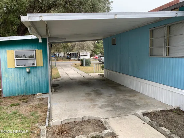 a view of a patio with table and chairs