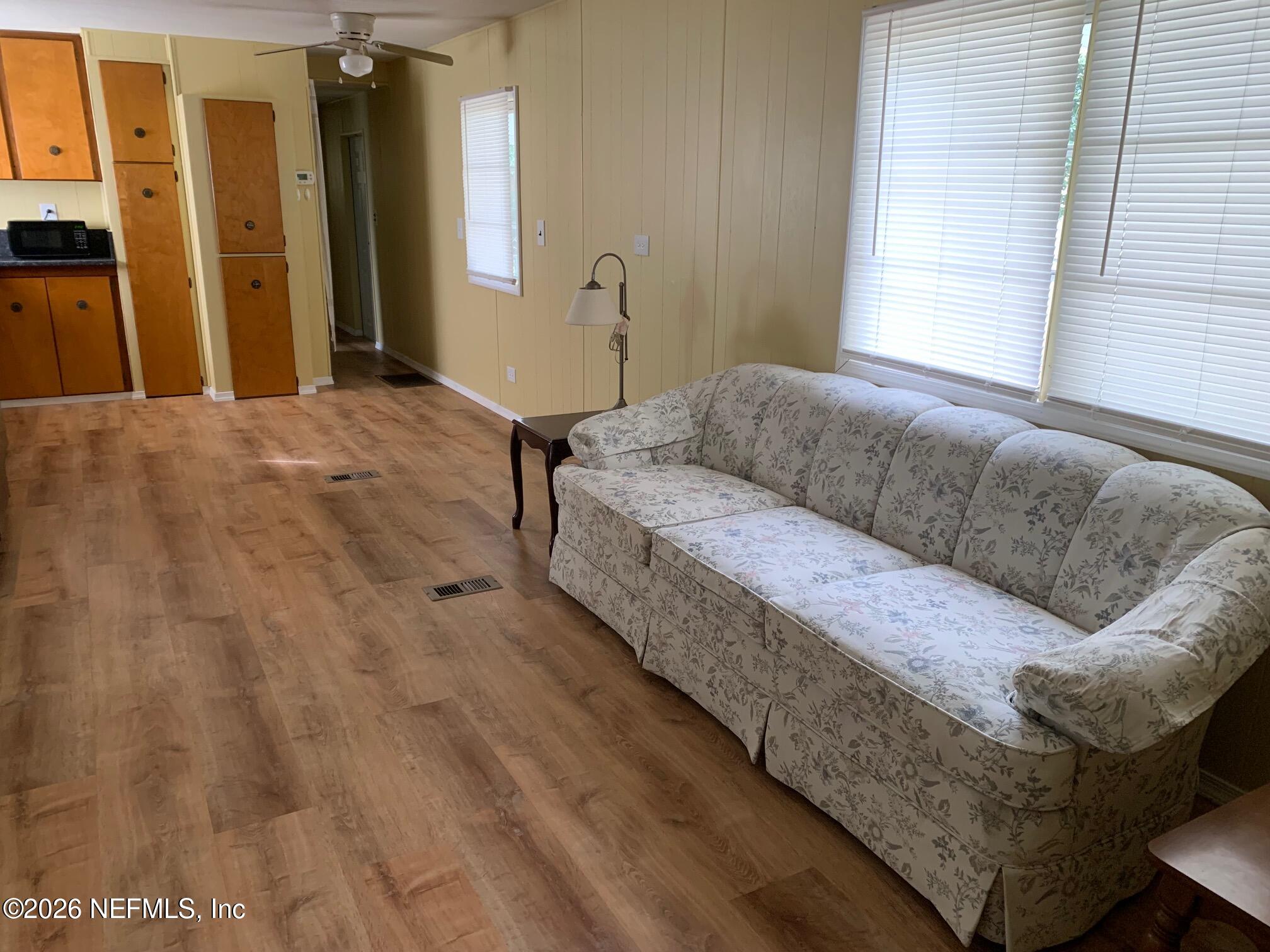 115 Sawyer Street Interlachen, FL 32148 - Photo 4 of 24 a living room with a couch and a window