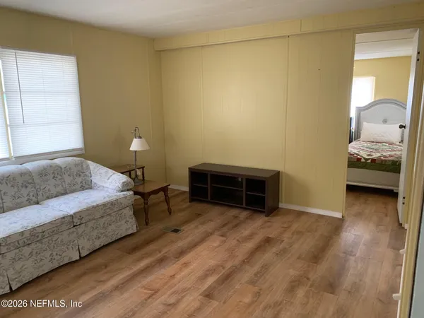 a bedroom with a bed and a chair