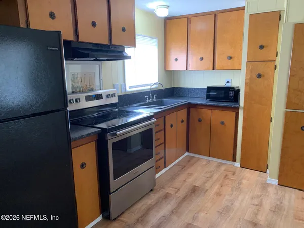 a kitchen with stainless steel appliances granite countertop a stove and a refrigerator
