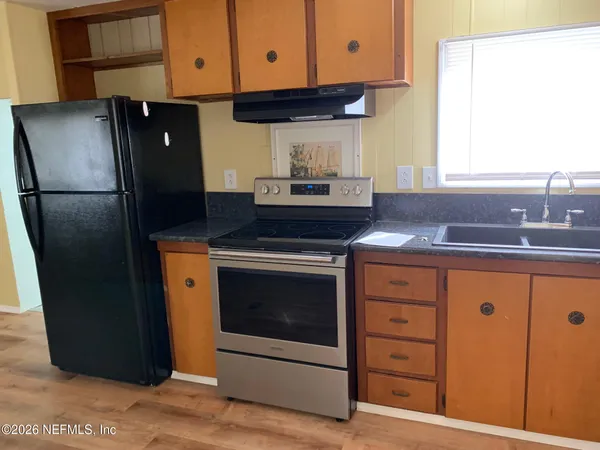a kitchen with stainless steel appliances granite countertop a refrigerator stove and sink