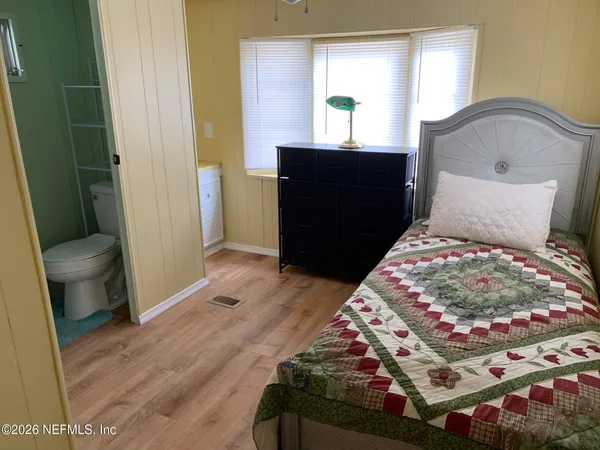 a bedroom with a bed and a mirror