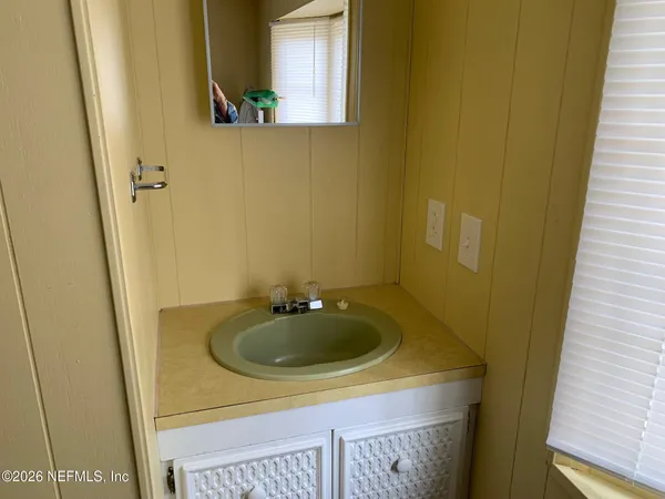 a bathroom with a sink and mirror