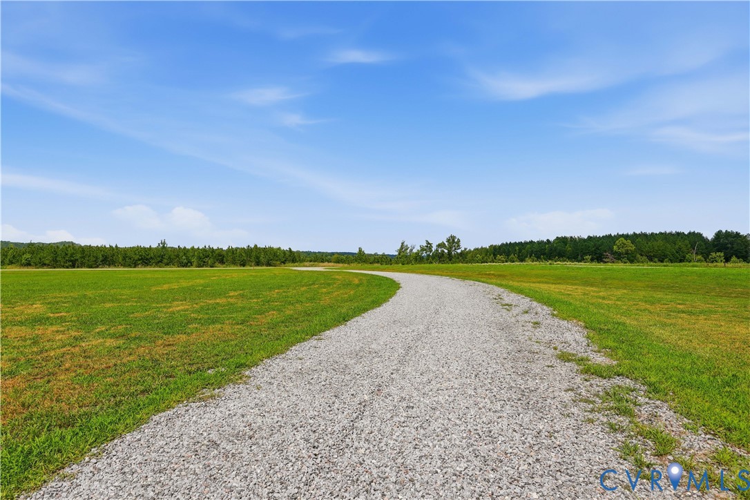 25181 West Soap Stone Road Jetersville, VA 23083 - Photo 3 of 54 Winding gravel pathway traversing expansive green