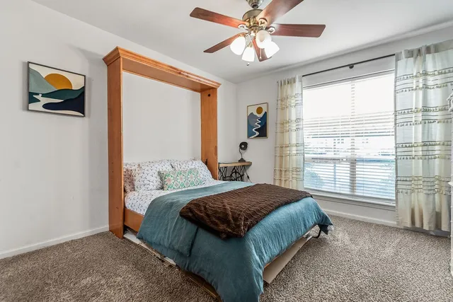 a bedroom with a bed and a dresser