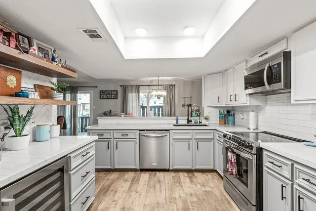 a kitchen with cabinets a sink and appliances
