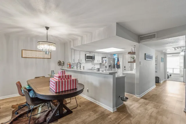 a view of a dining room with a table and chairs