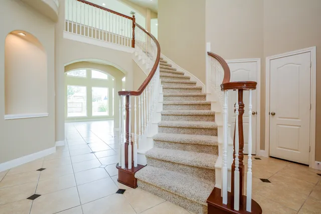 a view of staircase with white walls and a window