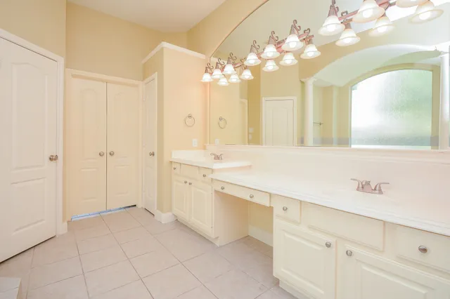 a spacious bathroom with a double vanity sink mirror and