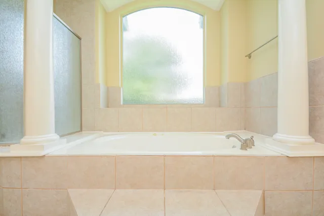 a bathroom with a bathtub and a window