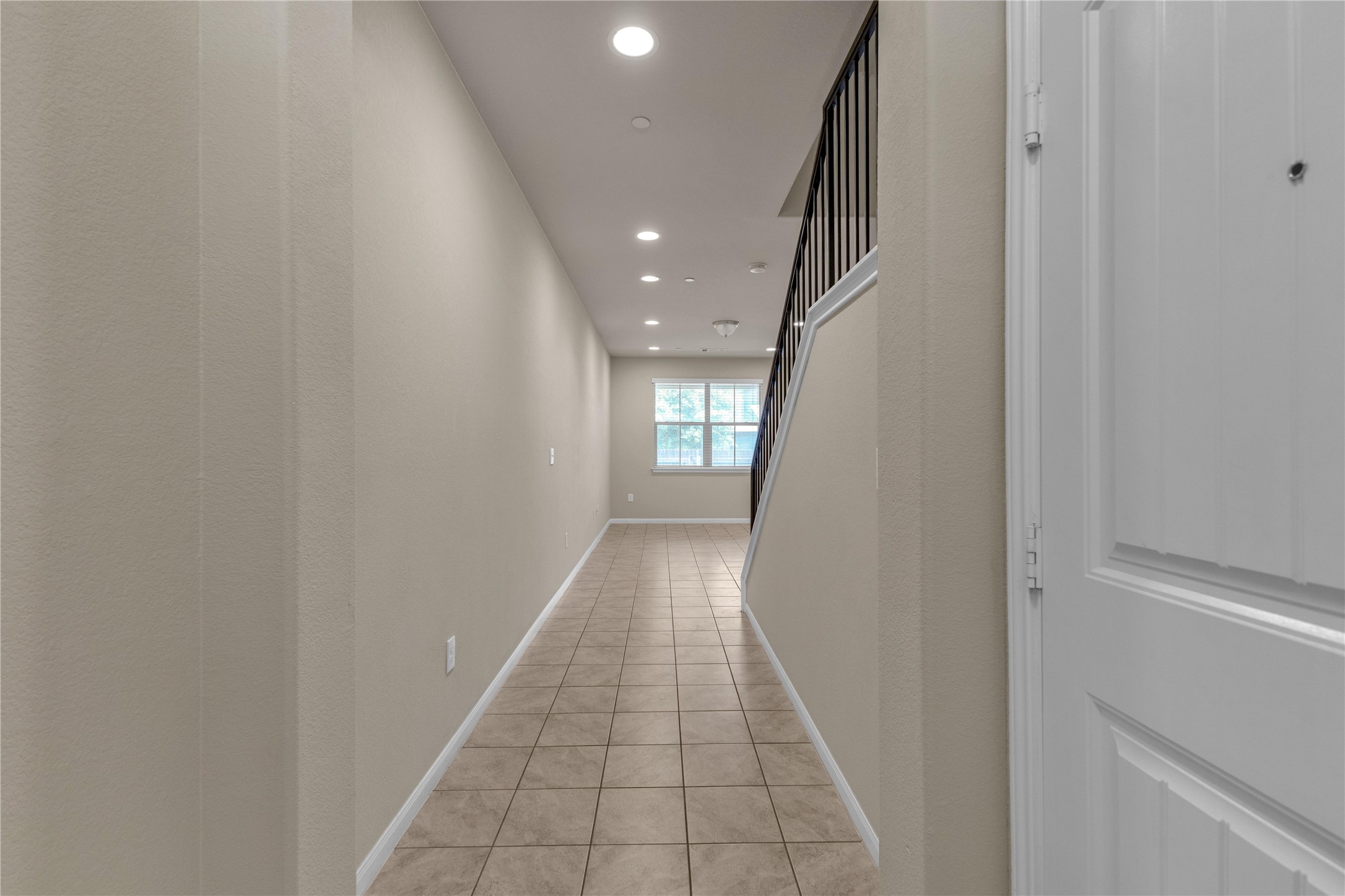 2880 Donnell Drive, Unit 2003 Round Rock, TX 78664 - Photo 3 of 31 Entryway featuring neutral-toned tile flooring, recessed lighting, and a white paneled door