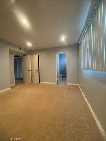 an empty room with window and pillar in it