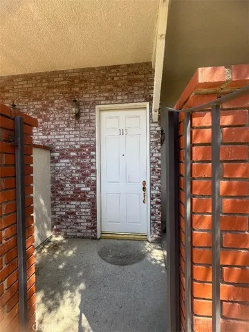 front view of a brick house with a large window