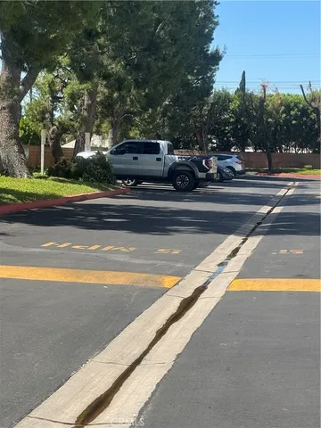 a view of swimming pool with outdoor seating and trees in the background