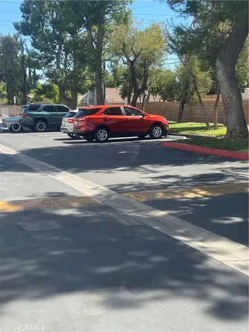 a front view of a house with a yard and car parked