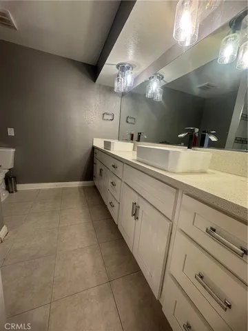 a bathroom with a sink a large mirror and vanity