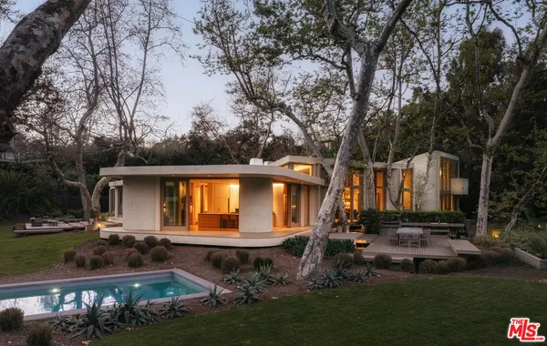 a backyard of a house with yard and outdoor seating