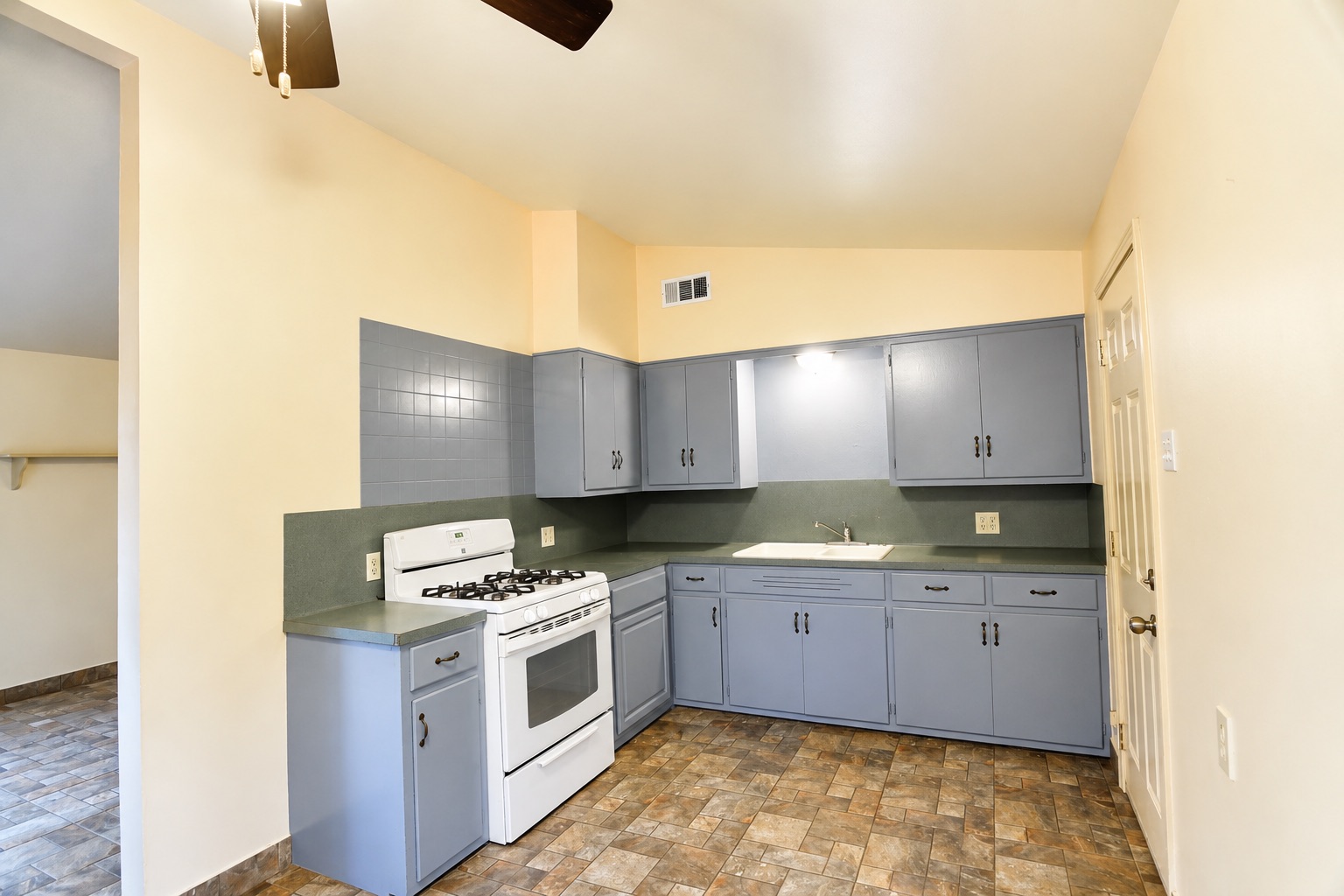 1508 Walnut Street Georgetown, TX 78626 - Photo 18 of 37 A well-equipped kitchen featuring an oven, range, and sink, ideal for daily meal preparation.