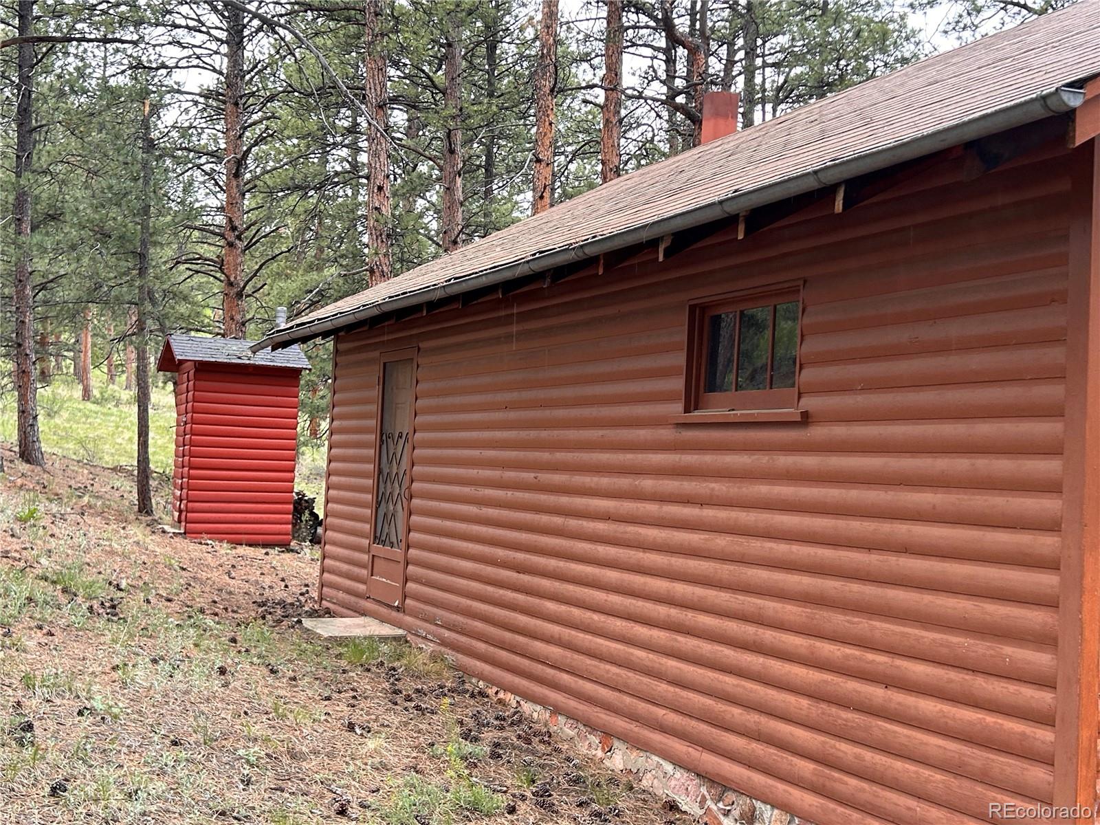 861 Happy Top Road Bailey, CO 80421 - Photo 11 of 29 a front view of a house with a yard