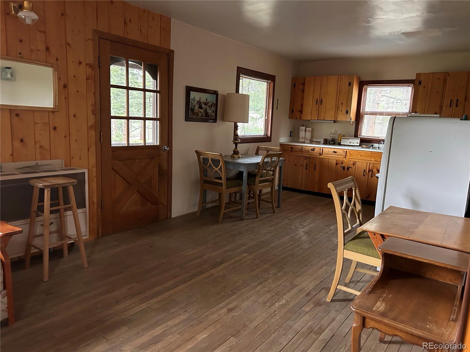 861 Happy Top Road Bailey, CO 80421 - Photo 14 of 29 a living room with furniture a dining table and wooden floor