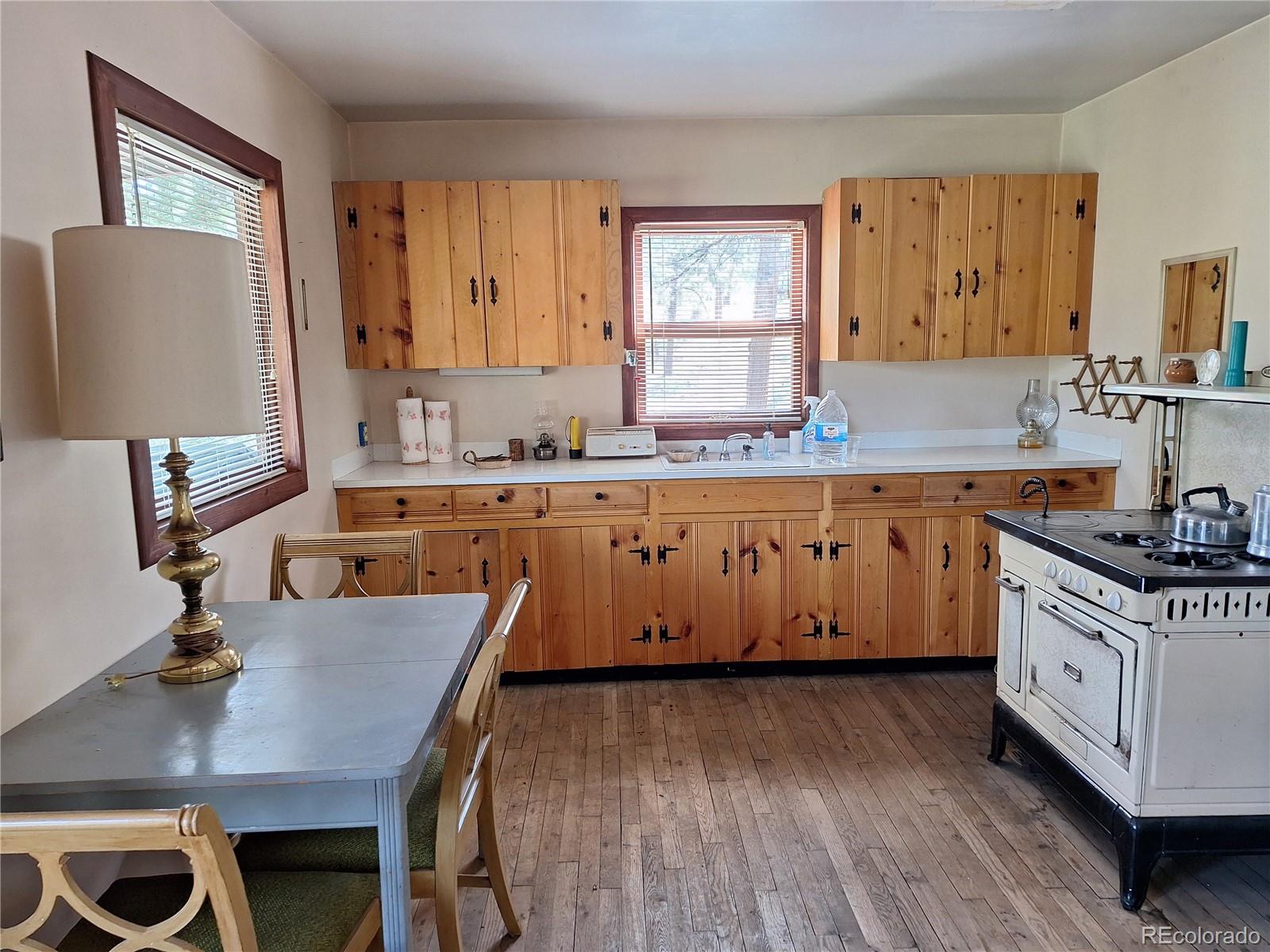 861 Happy Top Road Bailey, CO 80421 - Photo 3 of 29 a kitchen with a stove a sink a counter space and a refrigerator