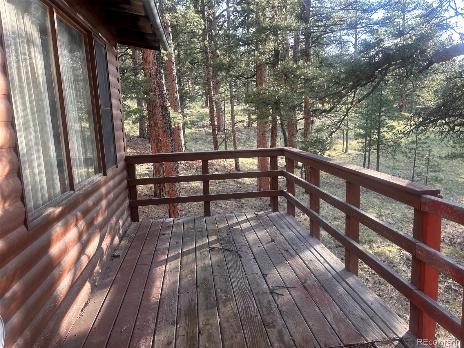 861 Happy Top Road Bailey, CO 80421 - Photo 7 of 29 a view of balcony with wooden floor and fence
