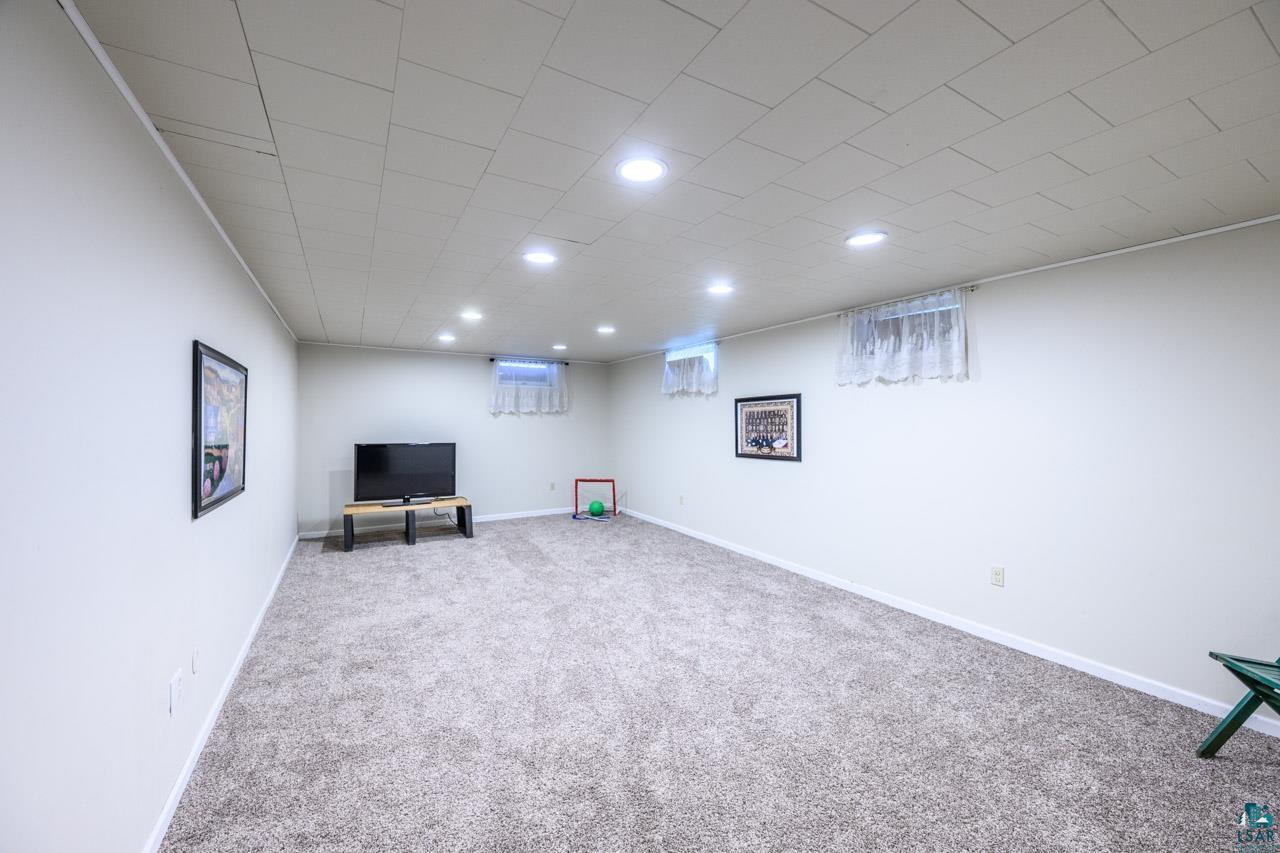 301 2nd Street North Biwabik, MN 55708 - Photo 20 of 43 Spacious room featuring neutral carpeting, light-colored walls, and a drop ceiling with recessed lighting