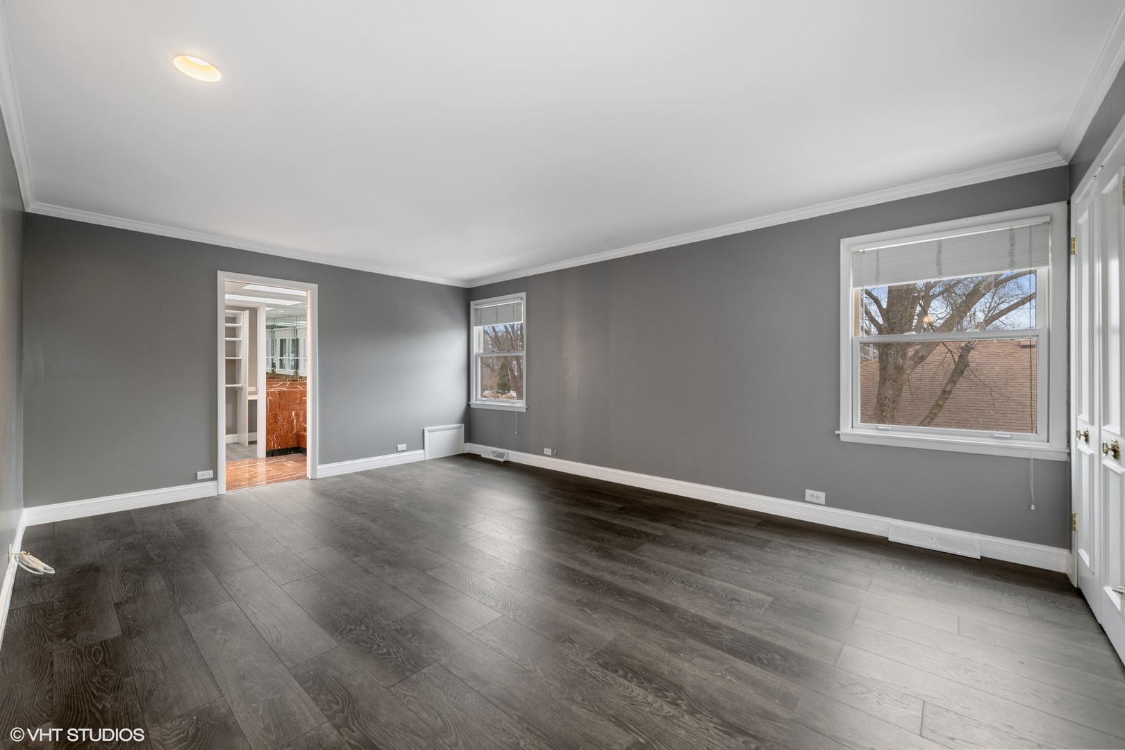 643 Robin Lane Glencoe, IL 60022 - Photo 23 of 32 an empty room with wooden floor and windows