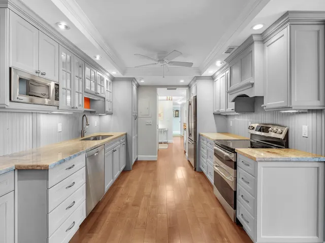a bathroom with a granite countertop sink a mirror a bathtub and a shower
