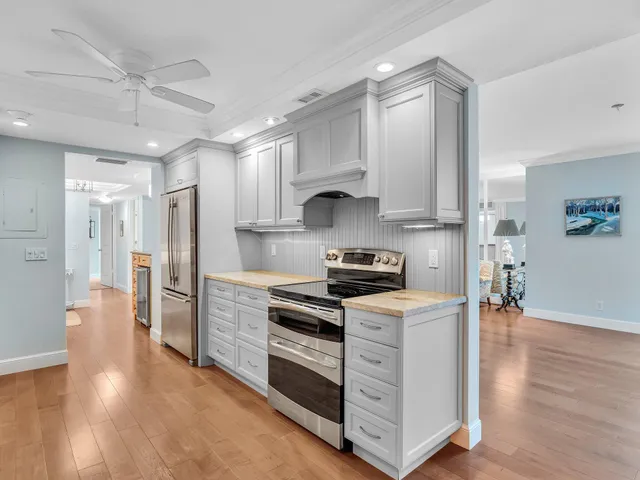 a front view of multi story residential apartment building with yard and parking space