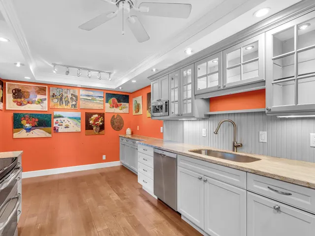 a living room with lots of furniture and view of kitchen