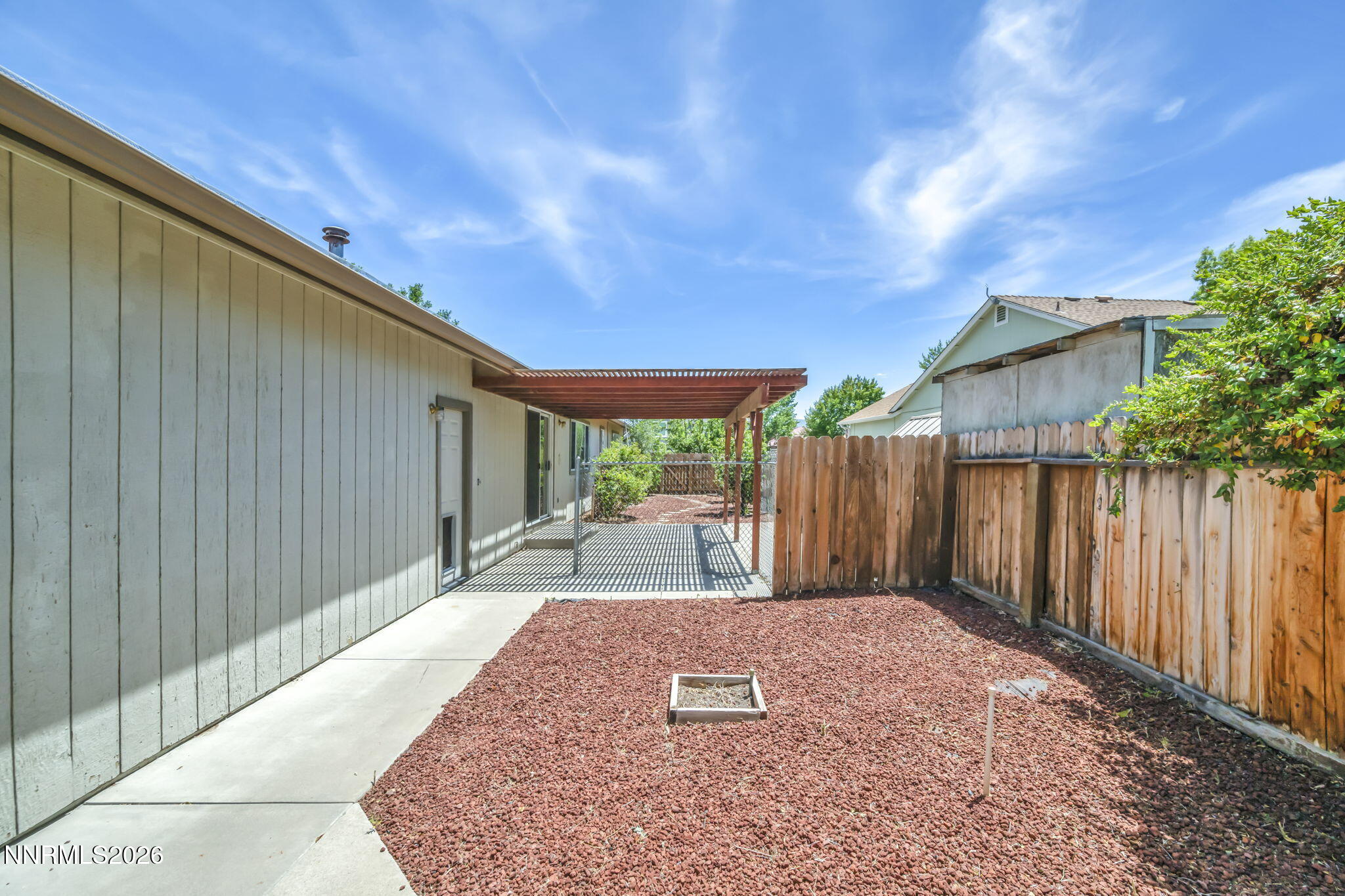 692 Lassen Way Gardnerville, NV 89460 - Photo 30 of 34 a patio with table and chairs and wooden fence