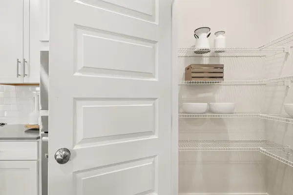 a bathroom with a glass door shower a sink and a toilet