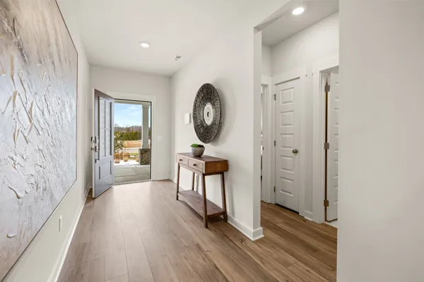 a view of a room with wooden floor entryway and wooden floor