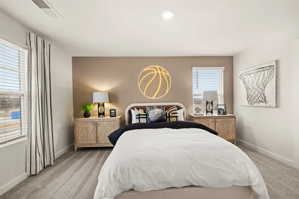 a spacious bedroom with a bed and a window