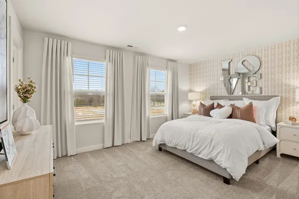 a bedroom with a bed and window