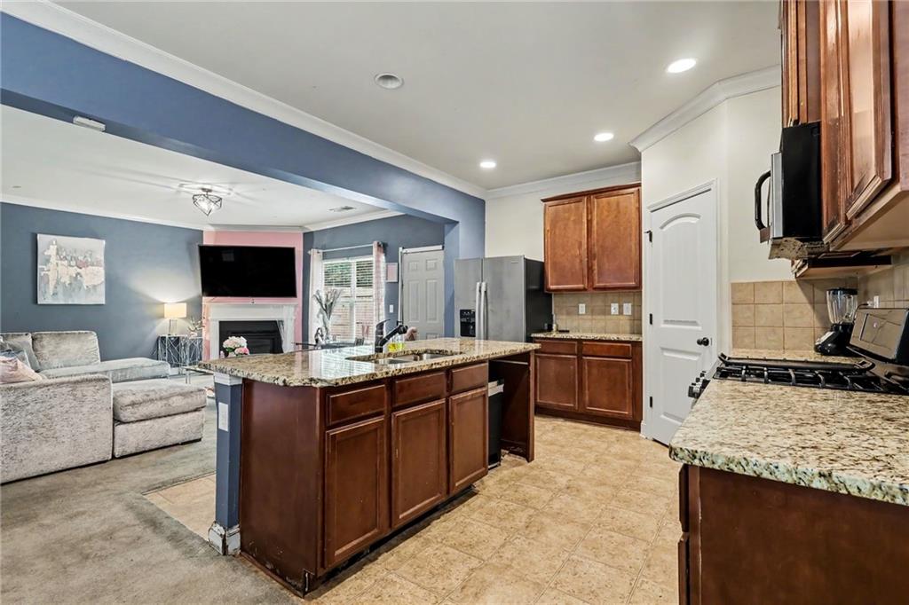 2780 Lakeview Walk Decatur, GA 30035 - Photo 13 of 37 a kitchen with stainless steel appliances granite countertop a sink stove and refrigerator