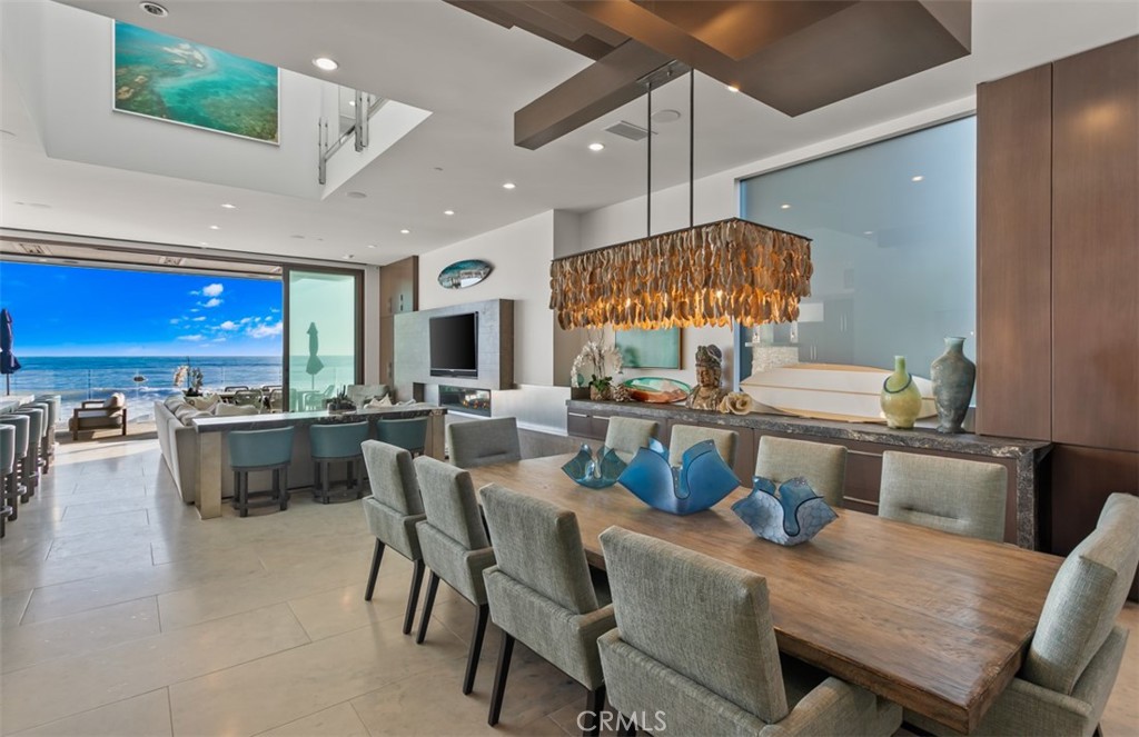 35461 Beach Road Dana Point, CA 92624 - Photo 14 of 46 a dining room with stainless steel appliances kitchen island granite countertop a table chairs and a stove