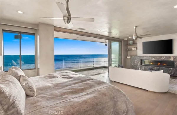 a spacious bedroom with a bed and a flat screen tv