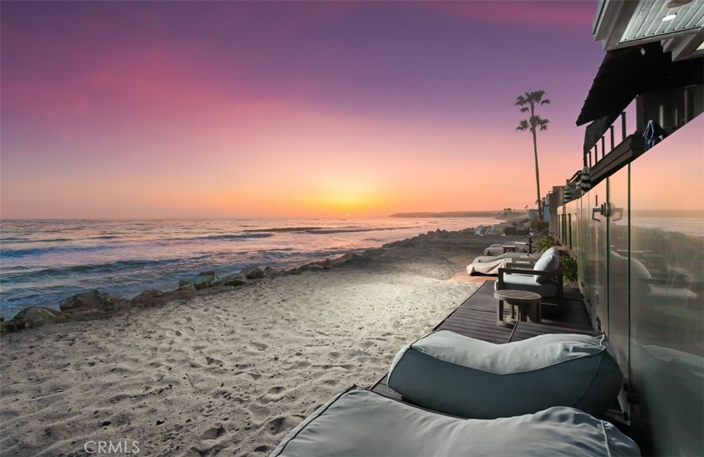 35461 Beach Road Dana Point, CA 92624 - Photo 3 of 46 a view of a lake with lawn chairs and wooden fence
